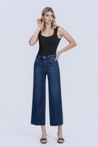 Flying Monkey High Rise Crease Line Trouser Wide Leg Jean in Caring, front view with hands on hips