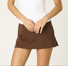 chocolate mini skirt, brown mini skirt, women’s mini skirt, fall mini skirt, stretch mini skirt, A-line mini skirt, chic brown skirt, trendy mini skirt, brown skirt outfit, contemporary mini skirt, faux suede mini skirt