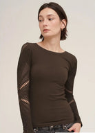 A woman wearing a dark brown long-sleeve ribbed knit top with open-knit lace sleeves, paired with dark jeans. A text overlay at the bottom right reads '2274 CHOCOLATE'.