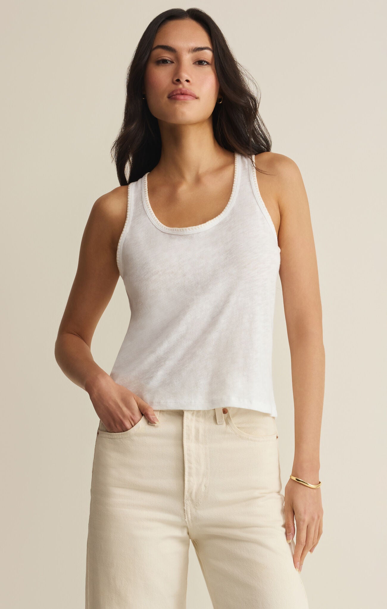 woman wearing a white tank top with crochet trim