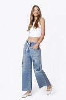 Flying Monkey High Rise Drawstring Wide Leg Drawstring in Flamenco, front three-quarter view with hands in pockets
