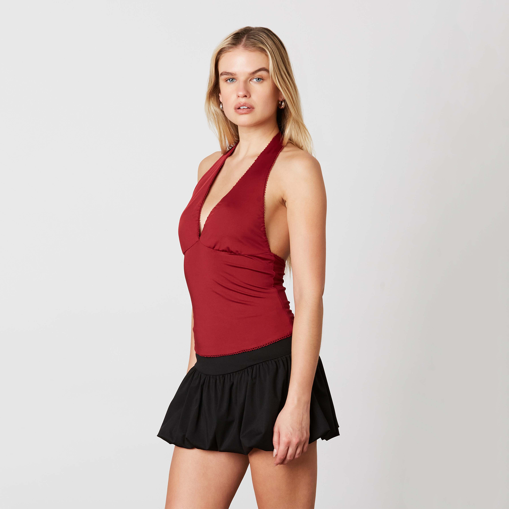 Turn heads in this flirty halter top! This halter features a sleek, slim-fitting silhouette that hugs you just right. The daring plunging neckline and bold open back add the perfect touch of drama, making it your go-to for a night out or a fun day out.