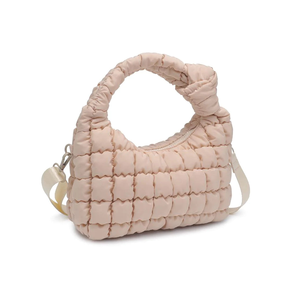 Sol & Selene Radiance Bag Cream. The Radiance bag exudes a subtle elegance with its puffy quilted nylon construction, designed for the fashion-forward and wellness-minded individual. Its chic design harmonizes with a practical form, offering an uplifting accessory for everyday grace and functional flair.