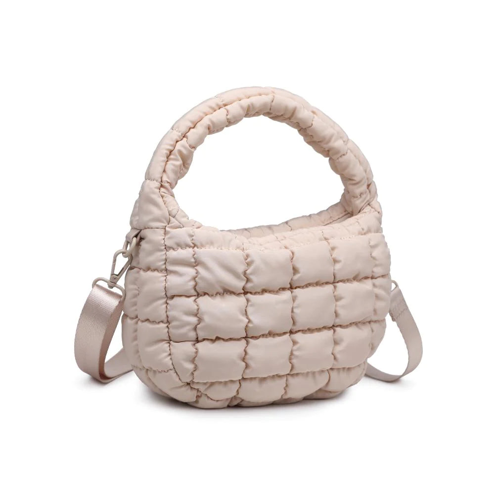 Leo Crossbody Cream. Made from sturdy nylon, this bag features a trendy puffy quilted design that adds an unexpected, eye-catching texture. Inside, the fabric-lined interior is home to a zip pocket that securely stashes your daily must-haves.
