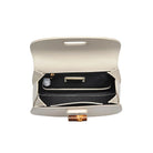 Allison Bamboo Crossbody Ivory. Crafted from smooth vegan leather, this bag features a sophisticated faux bamboo top handle and gold hardware for that touch of luxury. With an adjustable/detachable strap and a thoughtfully lined interior, it's not just a bag; it's a statement piece that keeps you organized on the go.