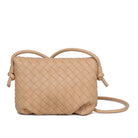 Kylo Crossbody Oat Milk. Elevate your look with the charm of this woven vegan leather crossbody. The knotted strap and gold hardware beautifully complement the envelope shape, creating an accessory that's both stylish and functional with its fabric-lined interior, including one zip pocket and one slip pocket.