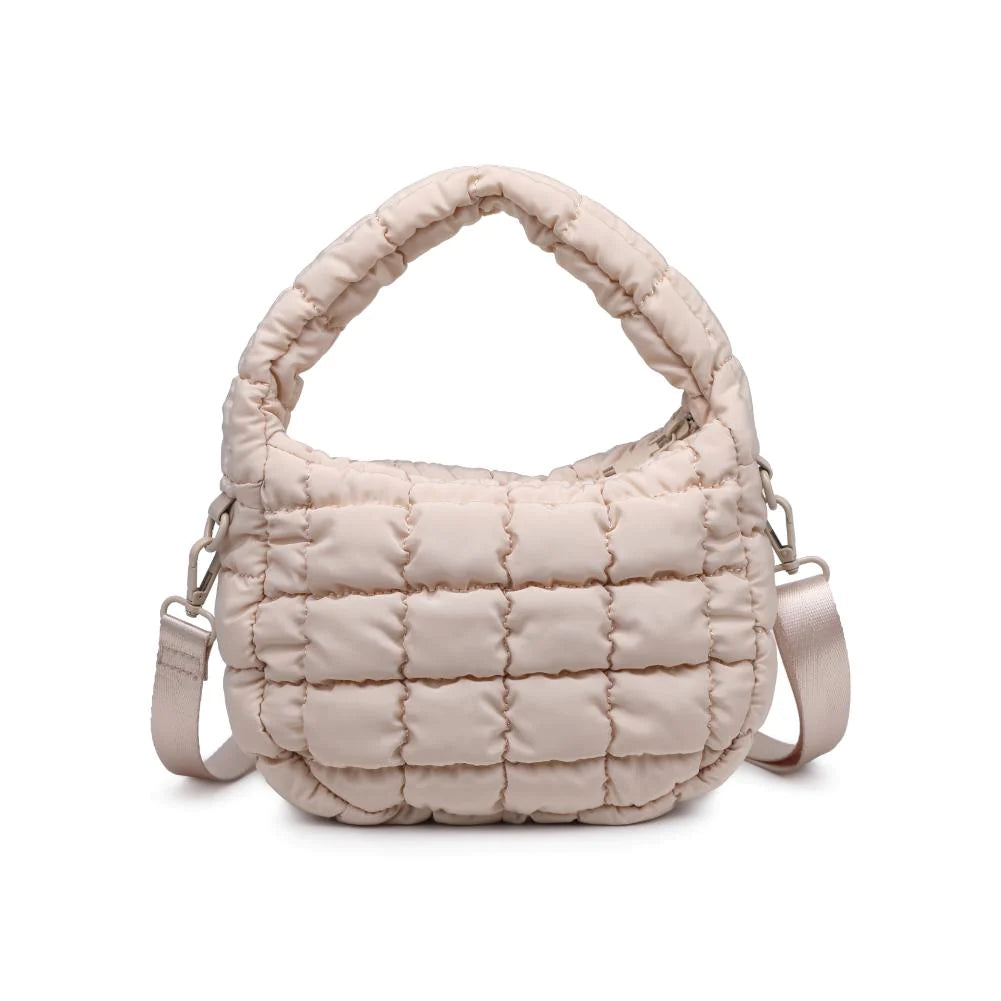 Leo Crossbody Cream. Made from sturdy nylon, this bag features a trendy puffy quilted design that adds an unexpected, eye-catching texture. Inside, the fabric-lined interior is home to a zip pocket that securely stashes your daily must-haves.