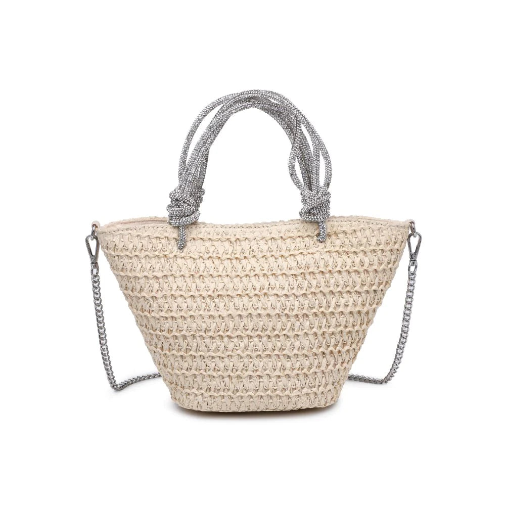 Gala Tote Ivory. Sparkle in Sunlight! This straw tote with a rhinestone knotted top handle is your companion for sunny days. The woven straw exterior, complemented by a detachable chain strap, effortlessly combines style and practicality. Inside, discover a fabric-lined interior with a zip pocket and slip pocket for your essentials.