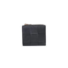 Amelie Wallet Black. The woven design and gold hardware make a fashion statement, while the snap button closure ensures your belongings stay secure. Inside, find a thoughtfully organized space with a main compartment, coin zip pocket, and eight card slots for maximum functionality.