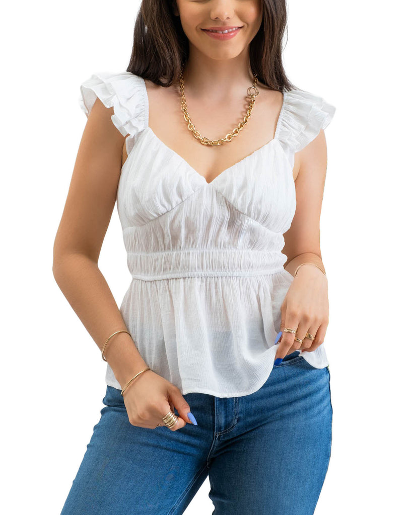 Yuliana Ruffle Sleeve Blouse White. This pretty ruffle sleeve blouse features a sweetheart neckline with a shirred waist and lightweight fabric that's perfect for the spring and summer with jeans or shorts.