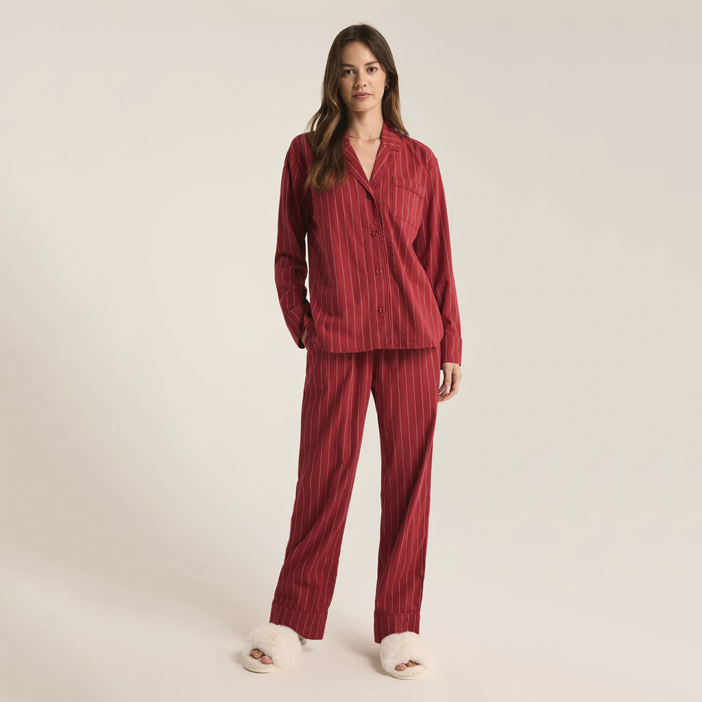 Snuggle up in this striped pajama set, crafted from soft-washed flannel for ultimate comfort. The top features a v-neck, collared button-front design with classic buttons, while the mid-rise, full-length pants offer an elastic waistband and side seam pockets. It’s the perfect cozy set to make your new go-to for relaxation.