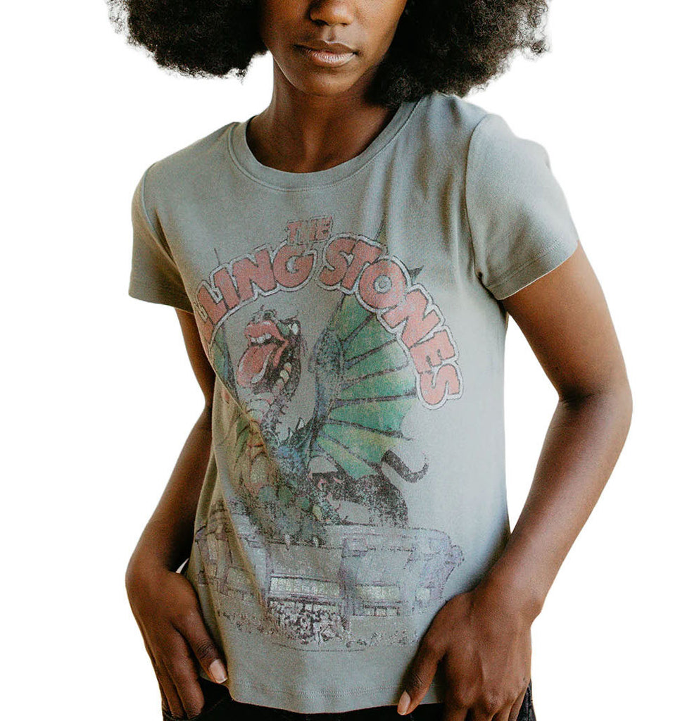 Rolling Stones Dragon Baby Tee Sage. This Rolling Stones Dragon Baby Tee features a graphic pulled directly from an authentic 1981 Stones concert tee. It features a dragon atop an arena, sticking out its iconic Stones tongue. This baby tee is ultra soft and flattering.