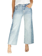 Model wearing high-rise ankle wide-leg jeans with contrast side panel detailing.