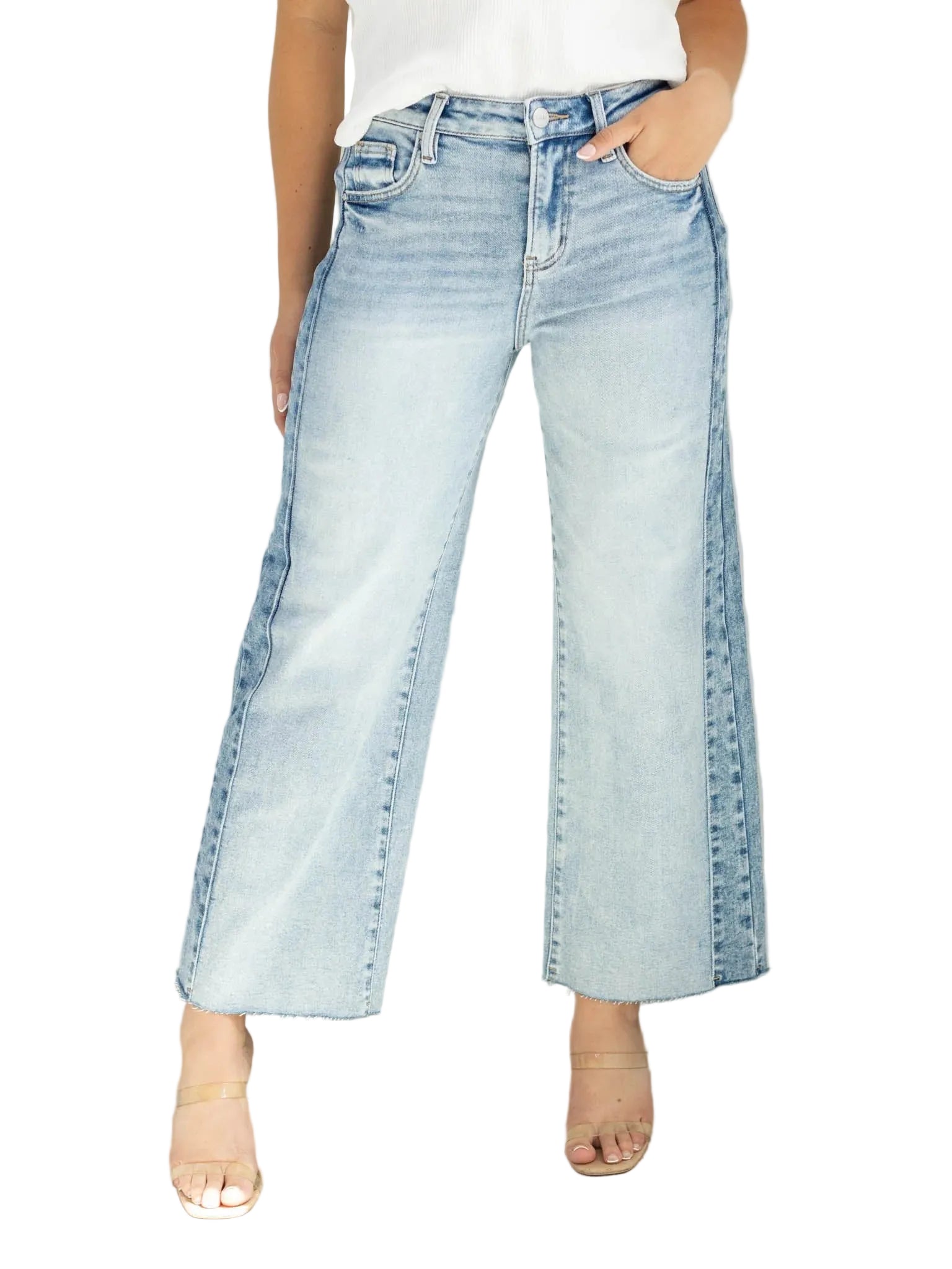 Model wearing high-rise ankle wide-leg jeans with contrast side panel detailing.