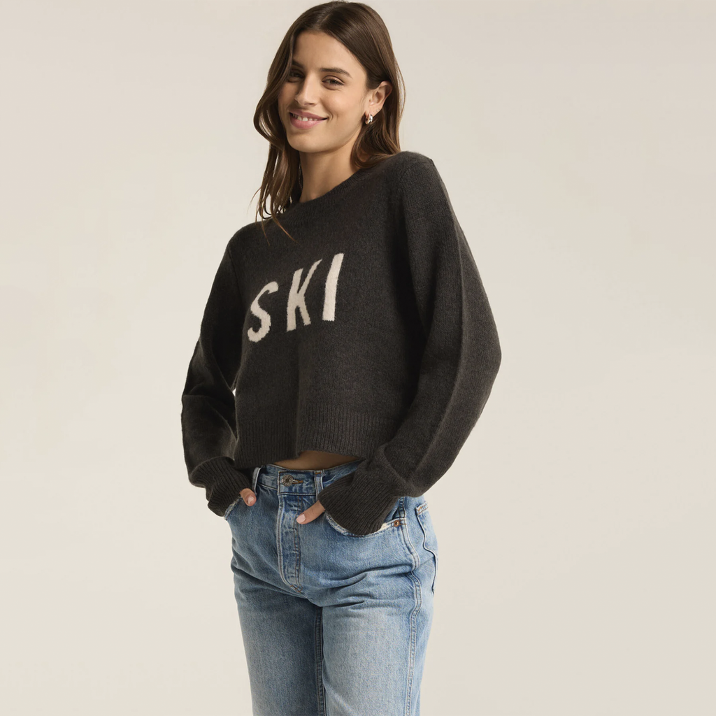 Stay cozy and stylish this winter with this plush feather yarn sweater, adorned with a fun intarsia "ski" graphic. The classic crew neck and long sleeves make it an ideal choice for après-ski gatherings or chilly winter days, adding a playful touch to your cold-weather wardrobe.