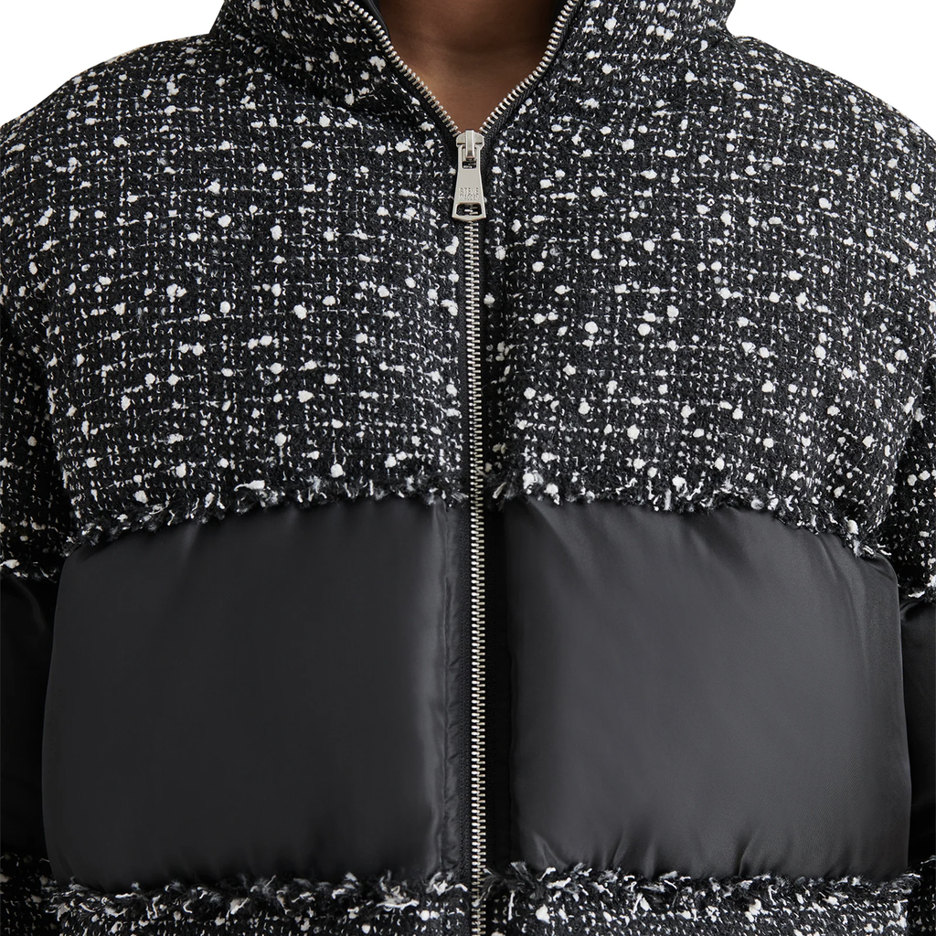 Stay warm and stylish this winter with the Steve Madden Snowdrop Puffer Jacket. Featuring a chic color block design in black and white tweed, this trendy puffer jacket boasts puffy sleeves, a high collar, and a zip-up front for a secure, flattering fit. Perfect for cold-weather fashion, it’s the must-have jacket for women who want to elevate their winter wardrobe.