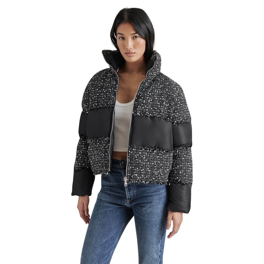 Stay warm and stylish this winter with the Steve Madden Snowdrop Puffer Jacket. Featuring a chic color block design in black and white tweed, this trendy puffer jacket boasts puffy sleeves, a high collar, and a zip-up front for a secure, flattering fit. Perfect for cold-weather fashion, it’s the must-have jacket for women who want to elevate their winter wardrobe.