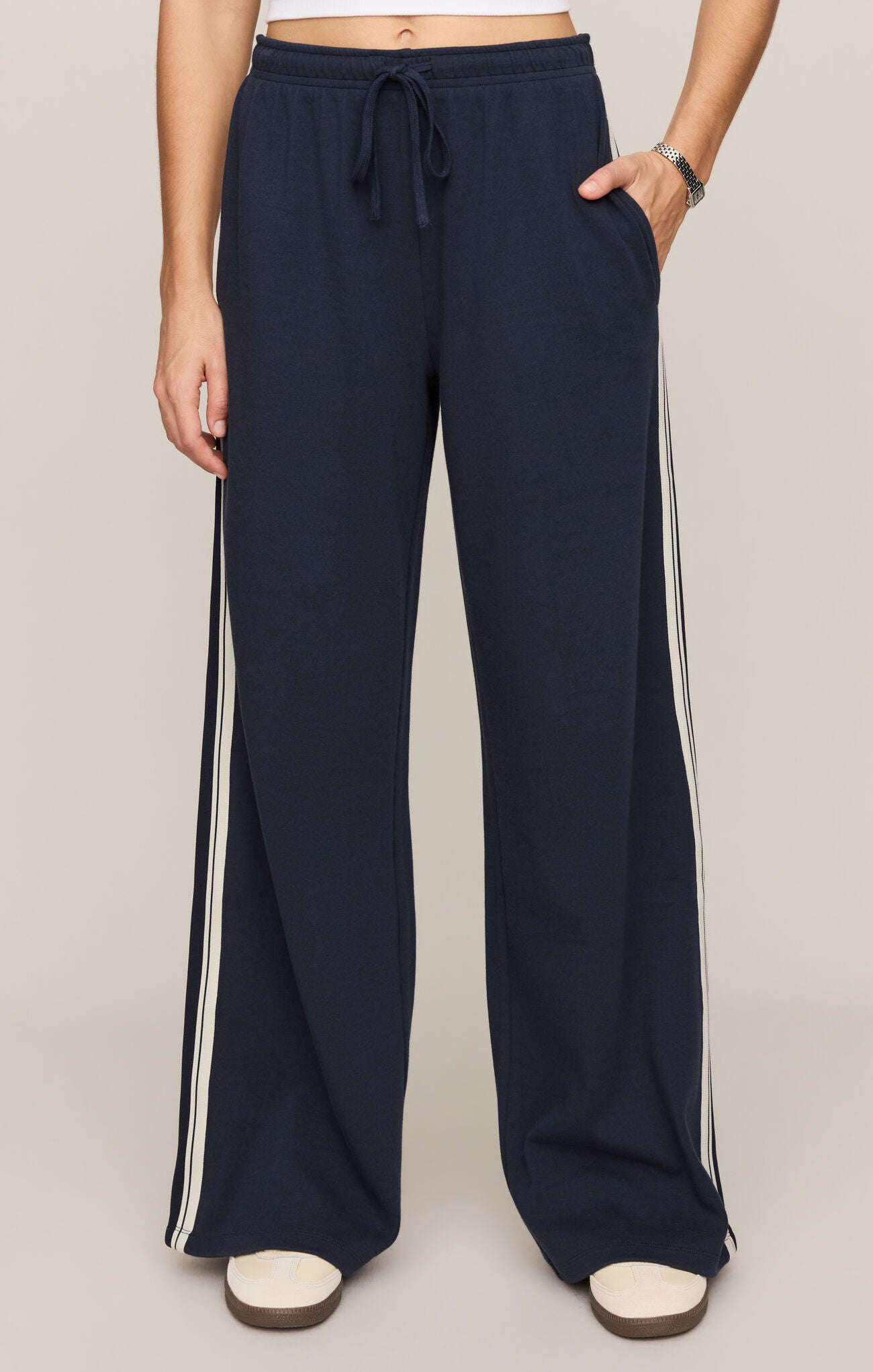 Wide-leg sweatpants with drawstring waist and contrast side stripe detail.