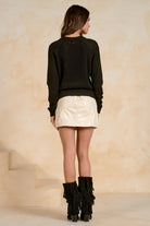Back view of a black crewneck raglan sleeve sweater.