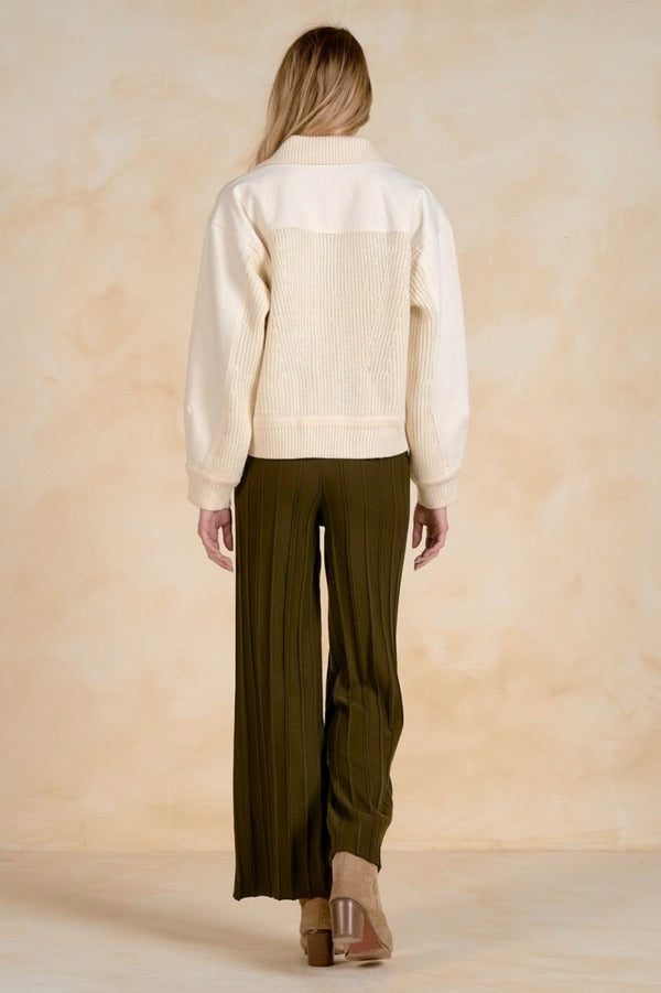 Back view of a mixed-media jacket with a textured back panel.