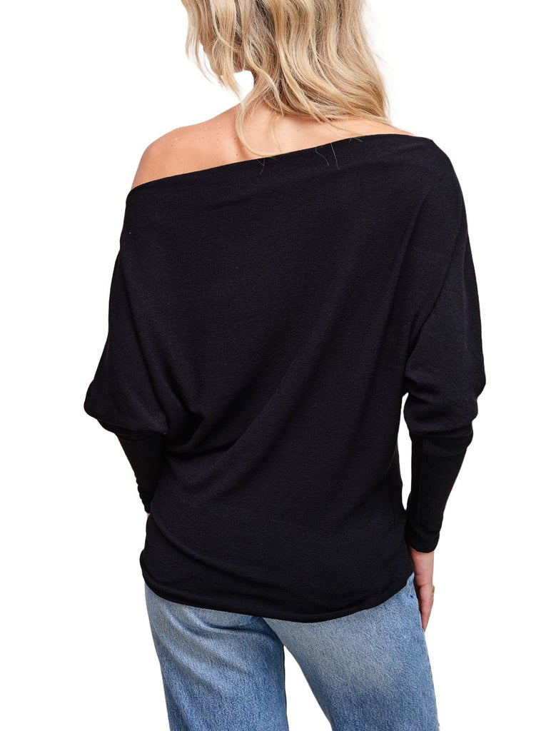 Misi Off Shoulder Crepe Top Black. This off shoulder crepe top comes in a soft hacci fabric and features dolman sleeves and a boat neck collar with an off shoulder design, perfect for any occasion.