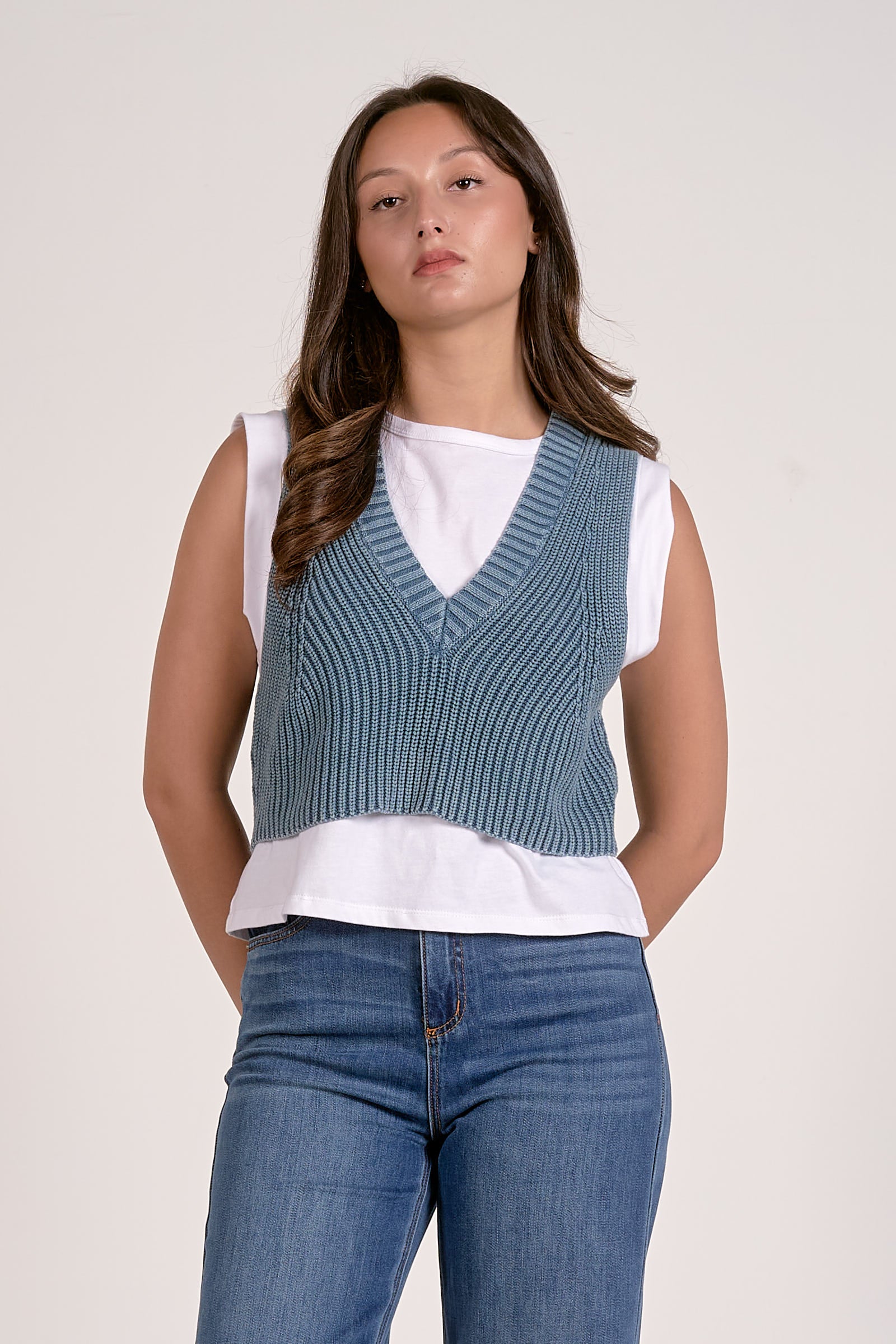 A ribbed knit sweater vest with a flattering v-neckline and modern cropped fit. Perfect for layering or wearing on its own for an effortless everyday look.