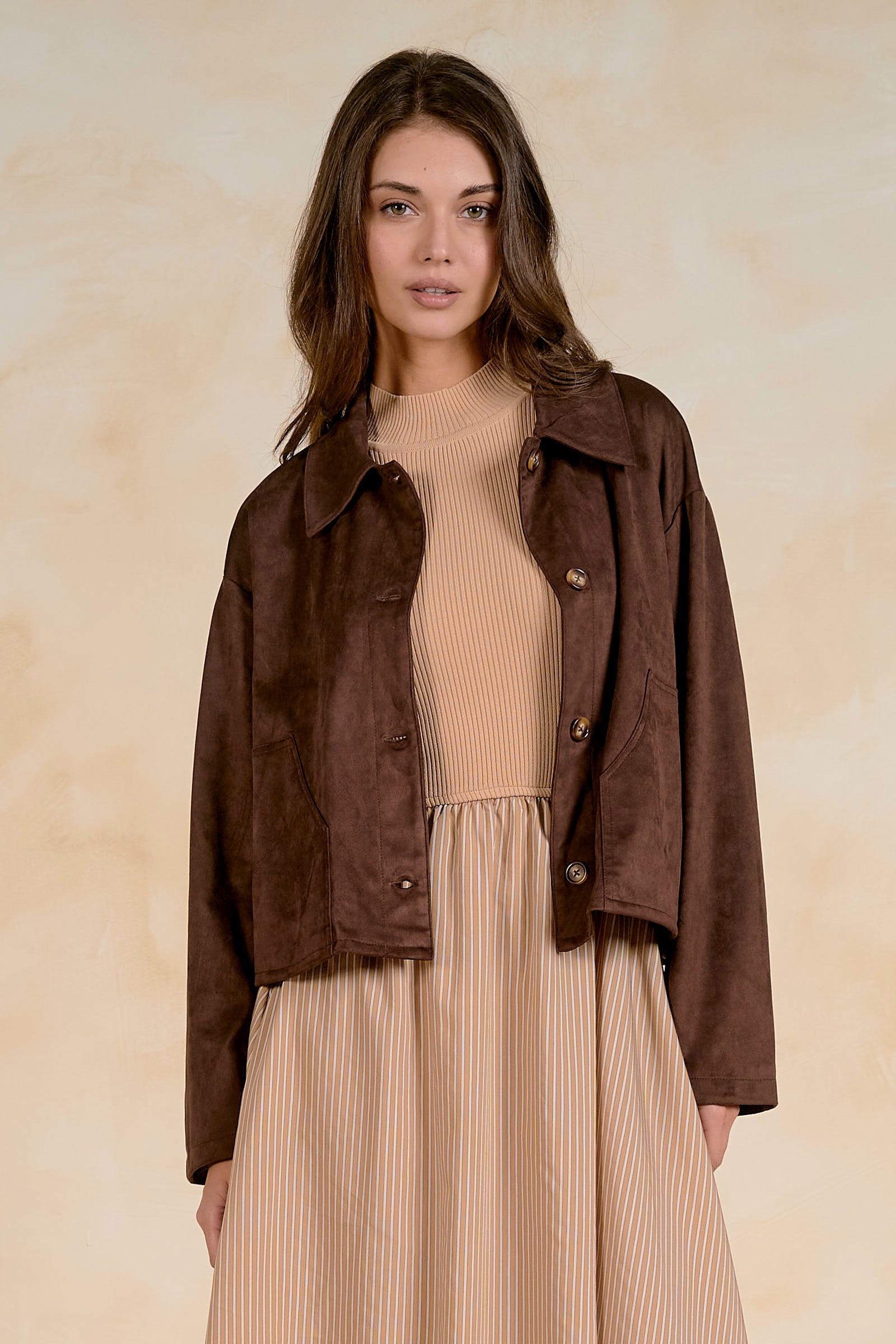 women wearing a faux sueade button cropped faux suede jacket with a collar