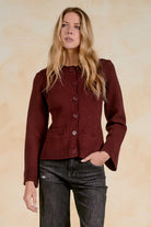 Women’s fitted button-front cardigan with front pocket details, ribbed trim, and flared cuffs.