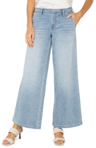 Woman wearing pull on wide leg denim jeans with a relaxed fit and smooth waistband styled with heeled sandals