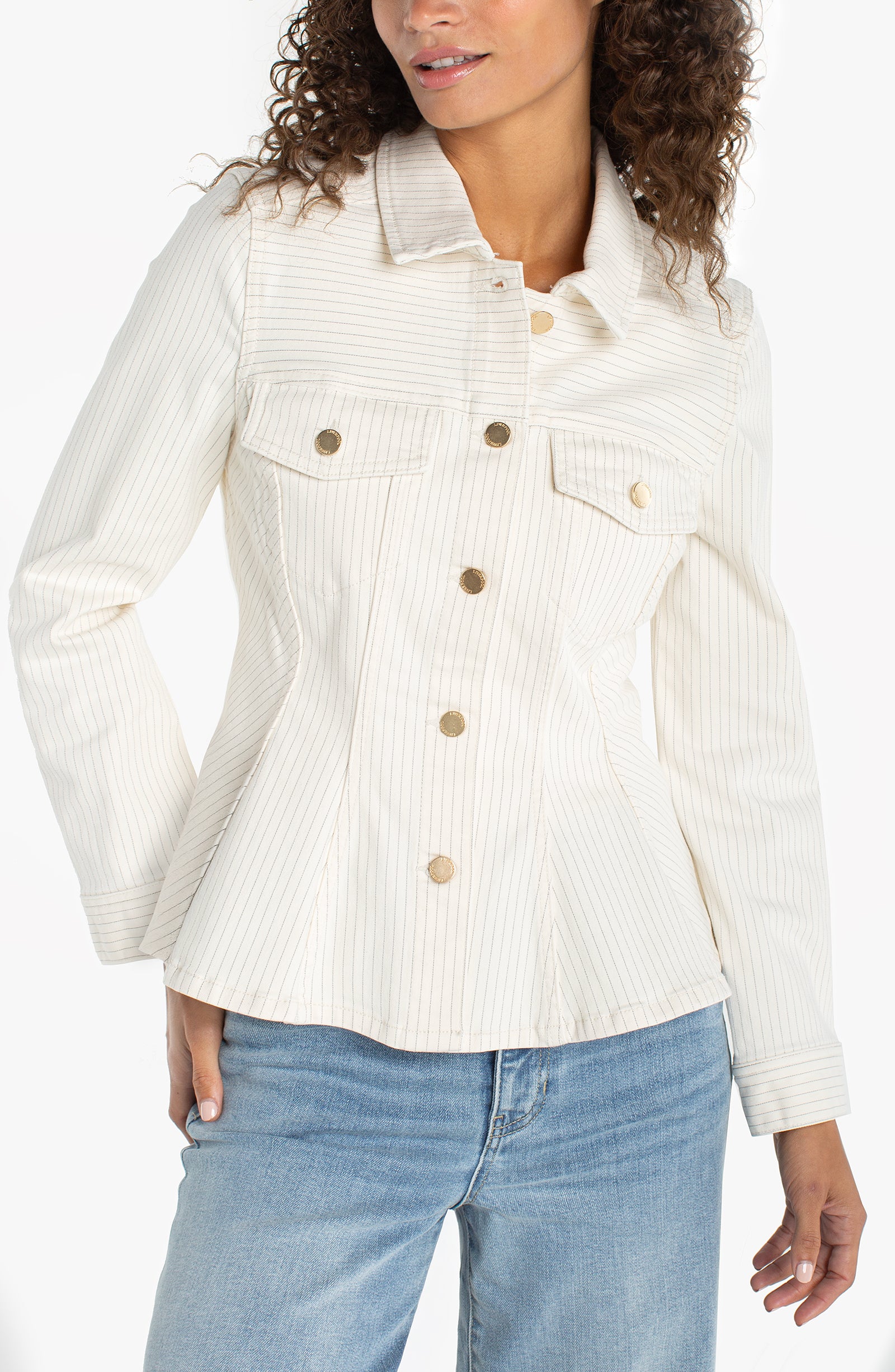 Woman wearing a tailored pinstripe button front top with gold buttons and utility pockets styled with denim jeans