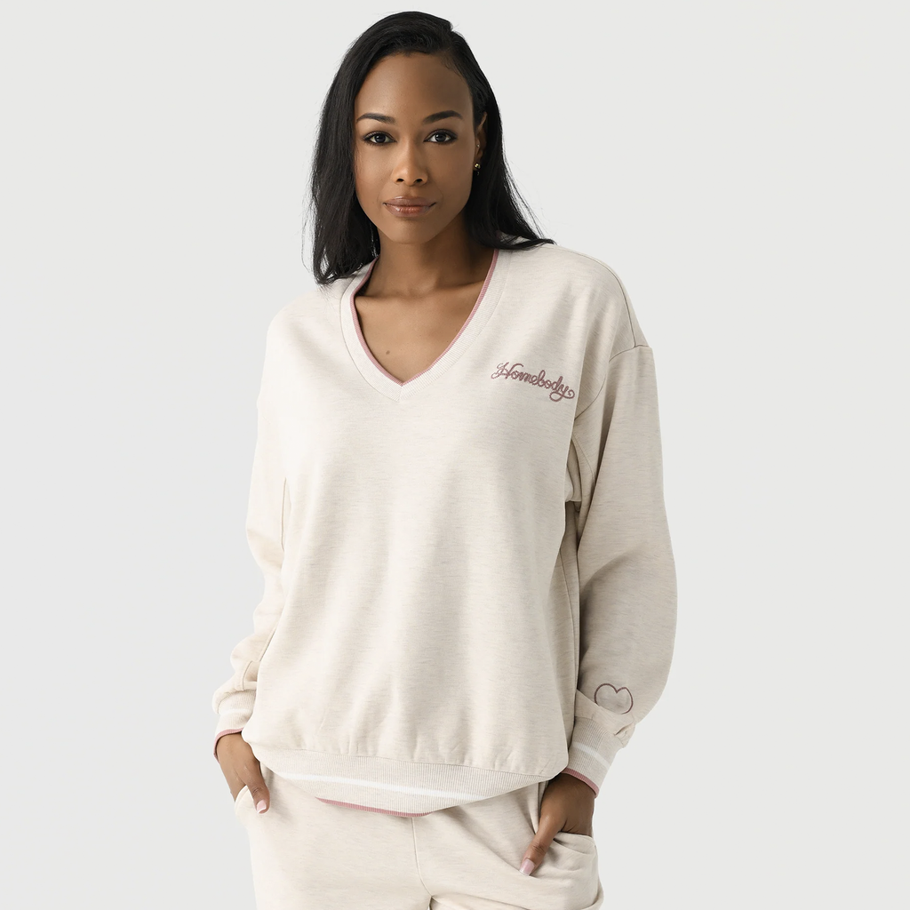 This cozy, oversized top is crafted from soft fleece, featuring contrast ribbed trims and subtle embroidered details for a touch of charm. Perfectly paired with the Homebody Pants, it creates the ultimate laid-back set for ultimate comfort and style.