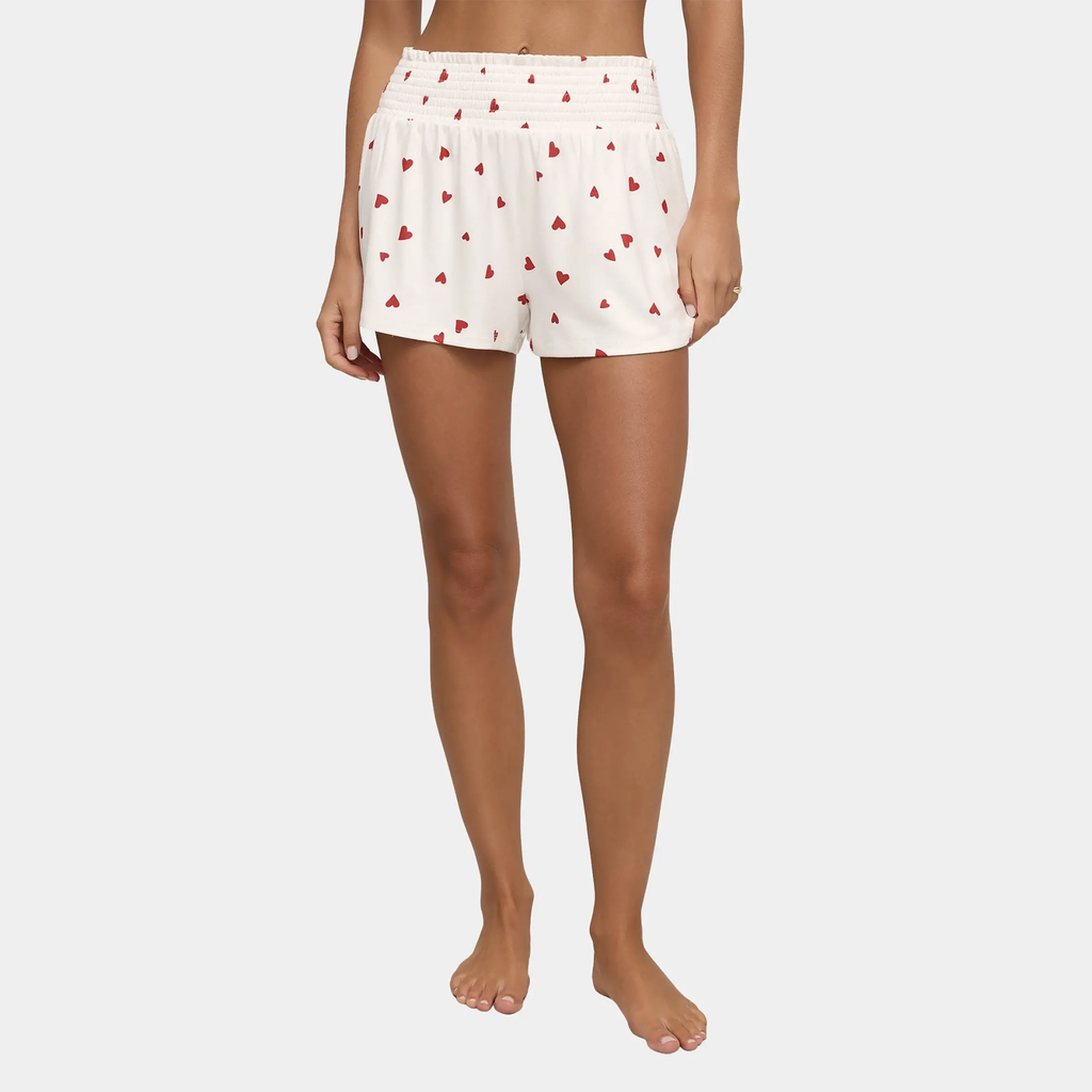 The Dawn Heart Shorts by Z Supply combine comfort and style in the most effortless way. With a smocked waist for a flattering fit and a playful heart design, these shorts are perfect for lounging, relaxing, or a cozy night in. Whether as pajamas or a casual day outfit, they're an essential addition to your wardrobe for both comfort and charm.