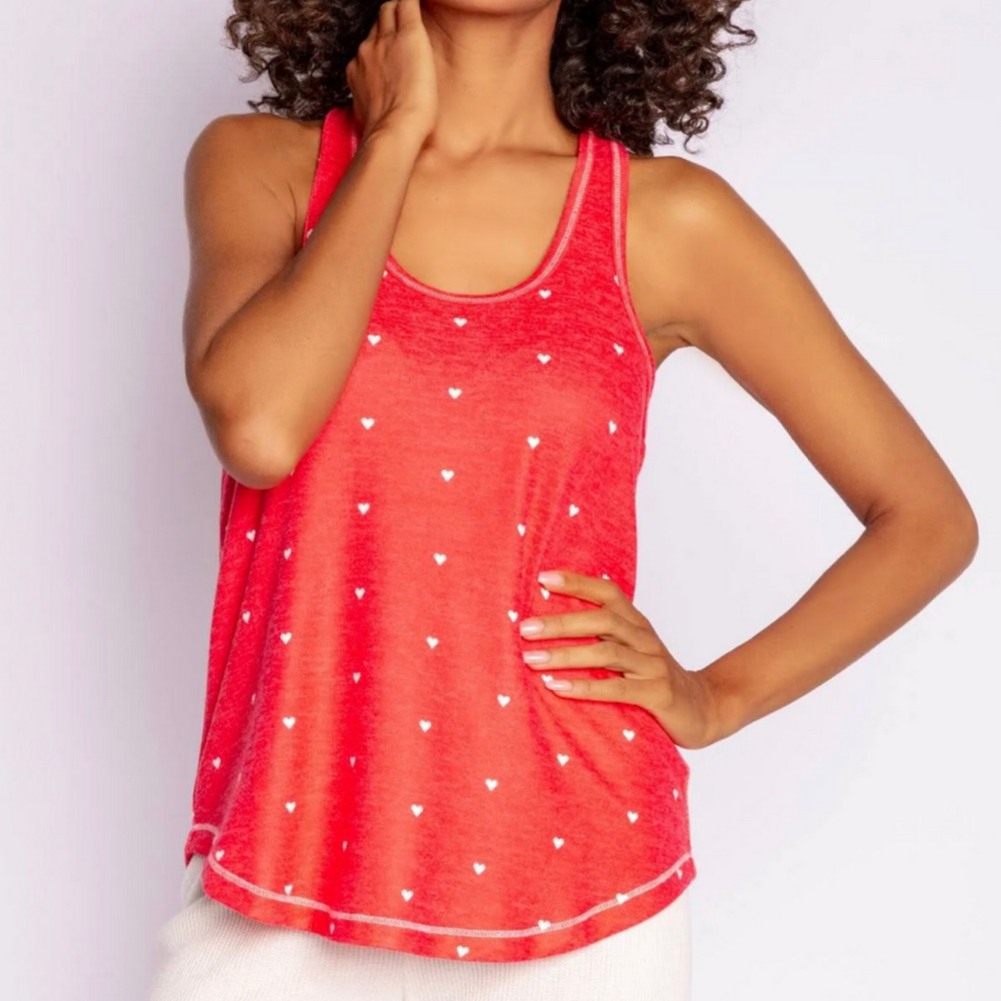 That pop color layering tank you love to wear. A bright color layered with a cardigan or with your favorite joggers. With a racer-back, in mini hearts print.