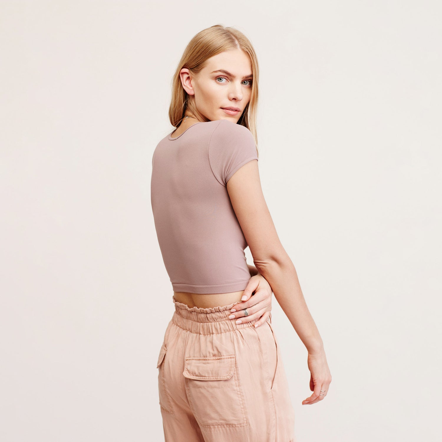 Free People Cap Sleeve Crop Top. A solid design lends versatile appeal to this cropped top by Free People. This basic crop top features a pullover style, crew neck, and short cap sleeves. Wear this with almost any bottom and sandals for a chic look.