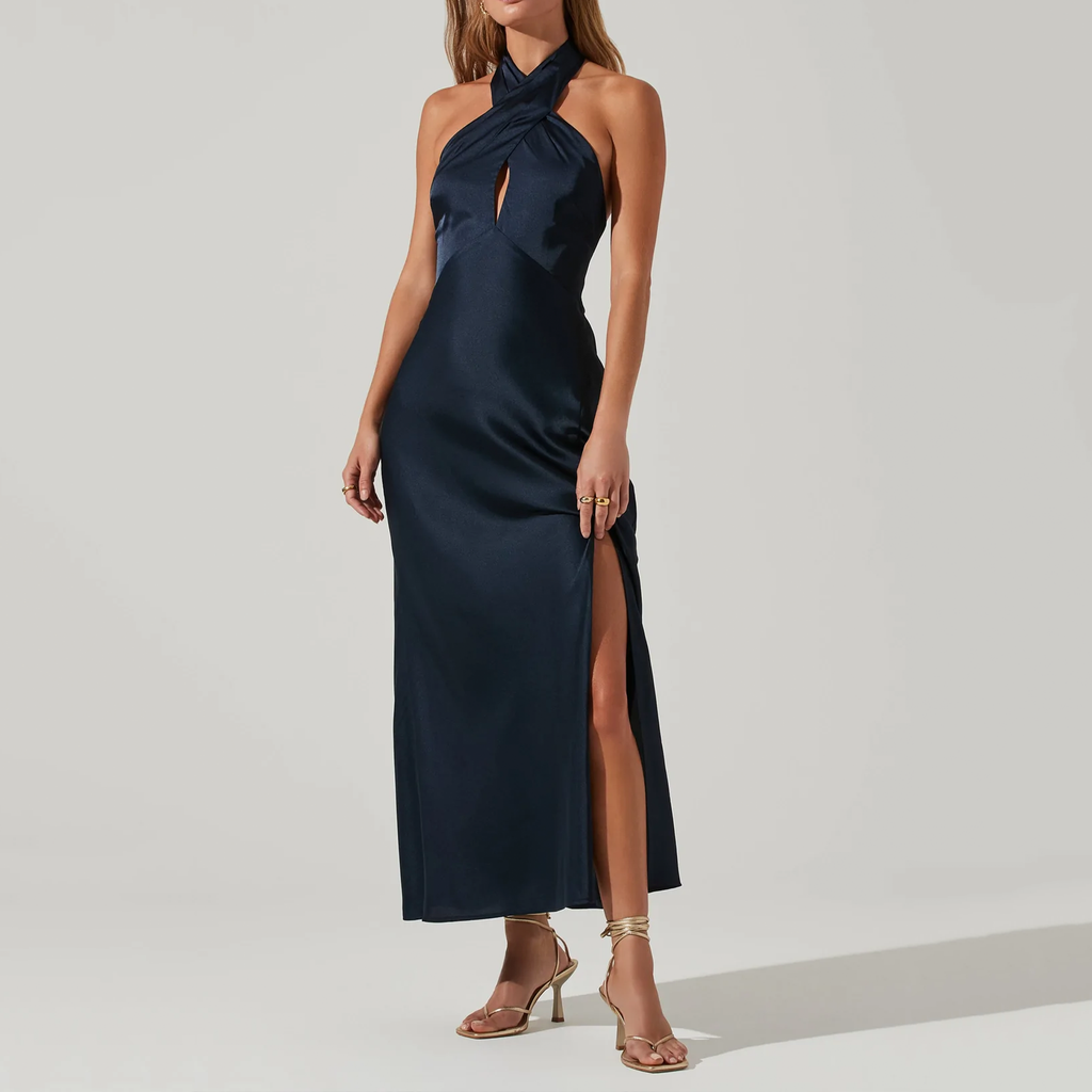 ASTR Marissa Dress. The Marissa Dress features a satin material that starts with a statement halter neckline and front cutout accent at the bust. Fitted silhouette leads to a side slit accent on a midi-length skirt. Button closures at the neck and concealed lower back zip closure