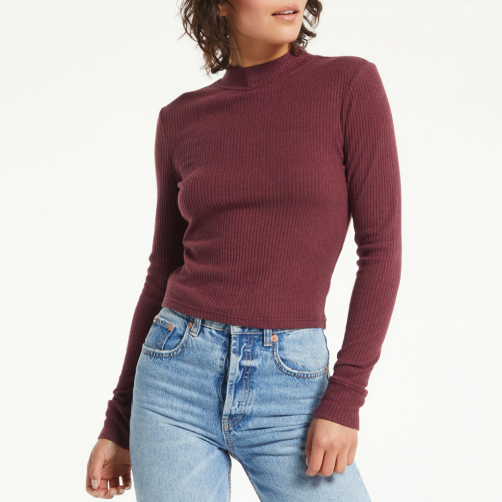 Z Supply Clarke Rib Long Sleeve Top. The soft textured rib creates an elevated, and flattering silhouette. This top will be that effortless addition with its fitted look, mock neck, and cuffed sleeve. Make it that must have!