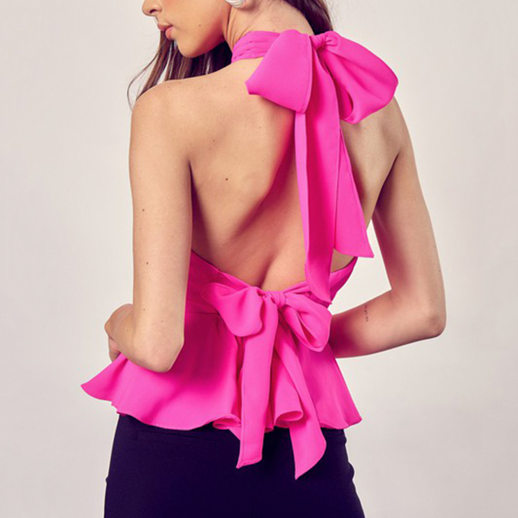 Halter Cross Peplum Tie Top. A sweet bow in the back gives this tie top a feminine touch. The crossover halter neck and peplum top are sure to make you look just as good as you feel