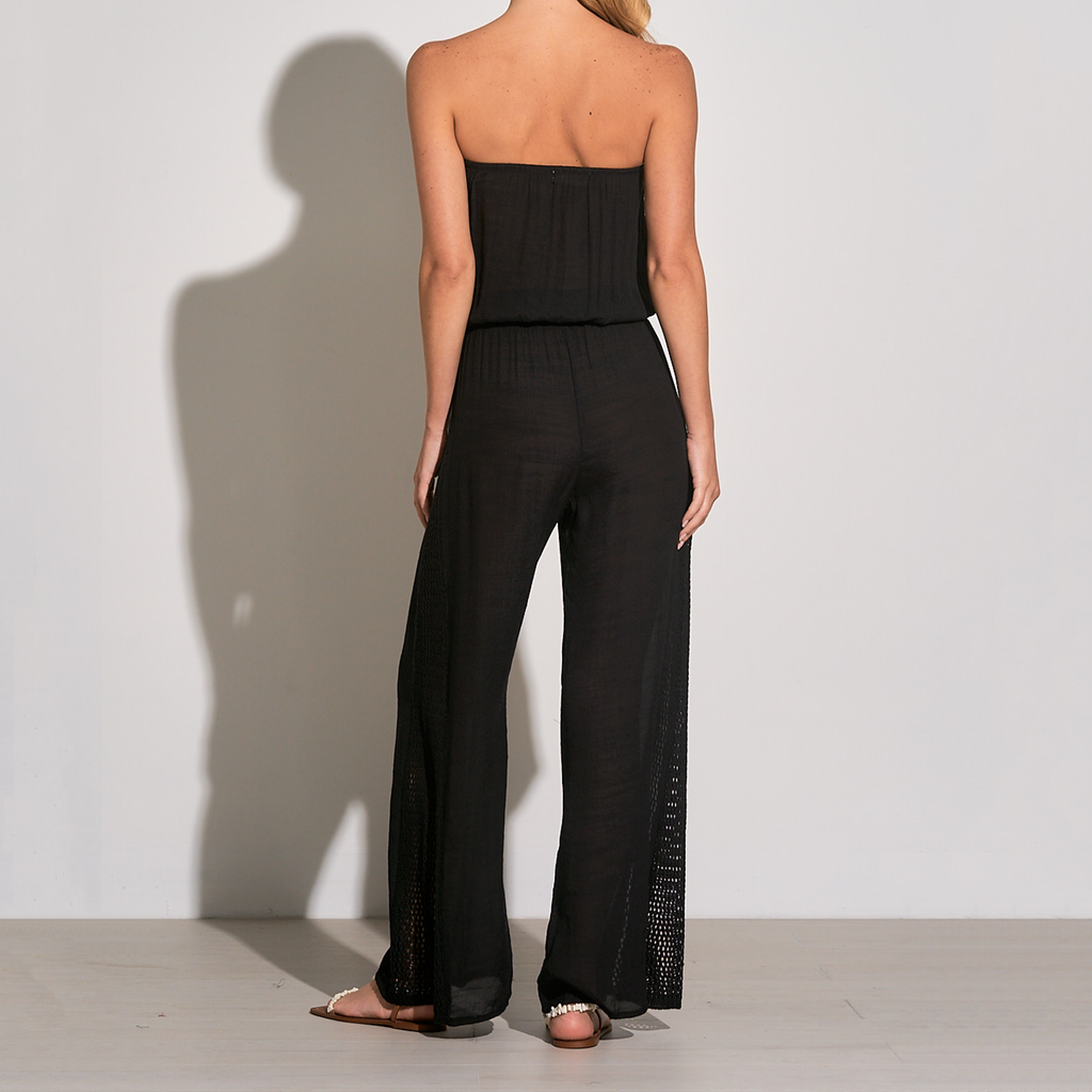 Elan Strapless Wide Leg Jumpsuit. This lightweight jumpsuit is designed in a strapless silhouette with wide vented hems and macramé trim