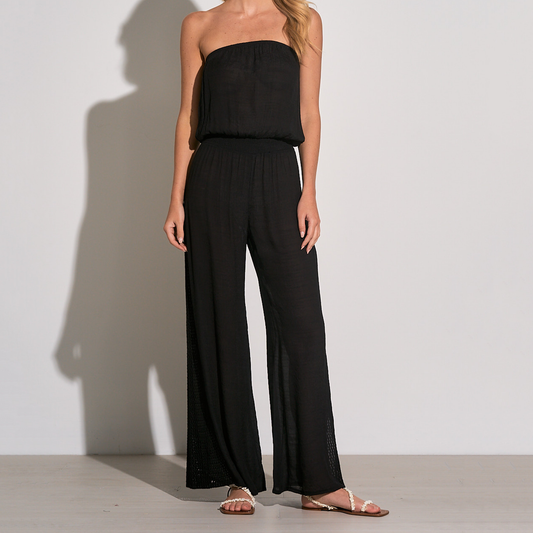 Elan Strapless Wide Leg Jumpsuit. This lightweight jumpsuit is designed in a strapless silhouette with wide vented hems and macramé trim