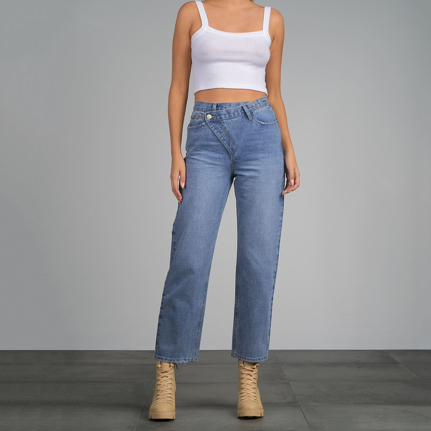 Elan Hi Waist Overlap Jean. These fun jean features an asymmetrical overlap front for a modern edge. Made in a soft all-cotton material, this trendy silhouette has a boyfriend fit and can easily be dressed up or down
