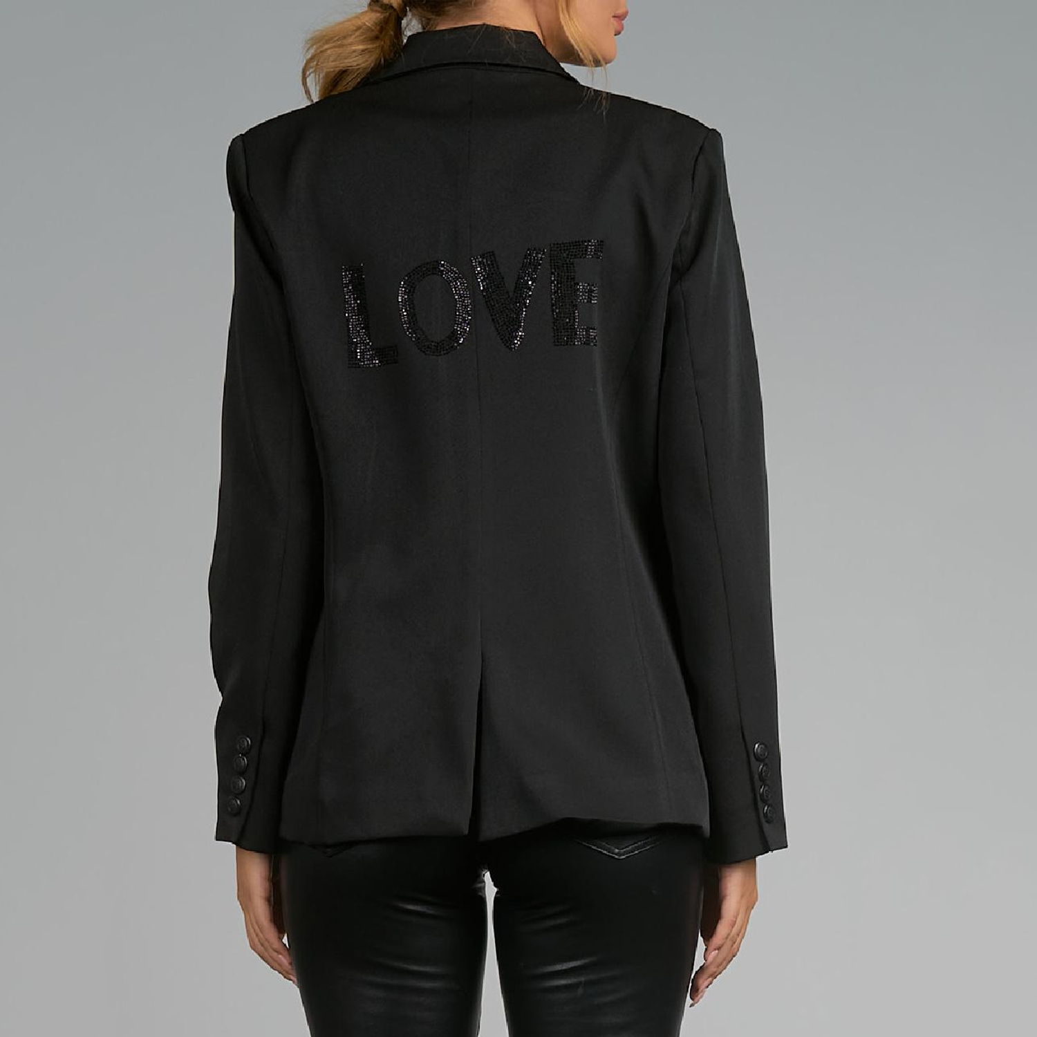 Elan Rhinestone Love Blazer. Make your casual days a bit more stylish with this layer ready blazer. Structured shoulders and a trim silhouette make this perfect for work or weekending. Best of all, the word "Love" is stoned onto the back for a dash of fun