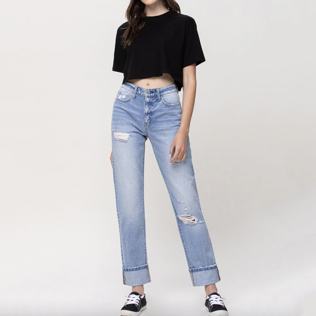High Rise 90's Vintage Straight Cuff Hem Jean. Follow the social media fashion trend in this high rise 90's vintage jean. The light washed denim with grinding details, cuffed hem, subtle fading, and whiskering gives this style the vintage vibe we're all going for