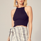 Ribbed Halter Knit Tank Top. We all need a little throw-on-and-go crop top like this Ribbed Halter Knit Tank Top! This cute top is made from a stretchy, ribbed knit and features a sleeveless, fitted bodice with a high neckline and racerback design