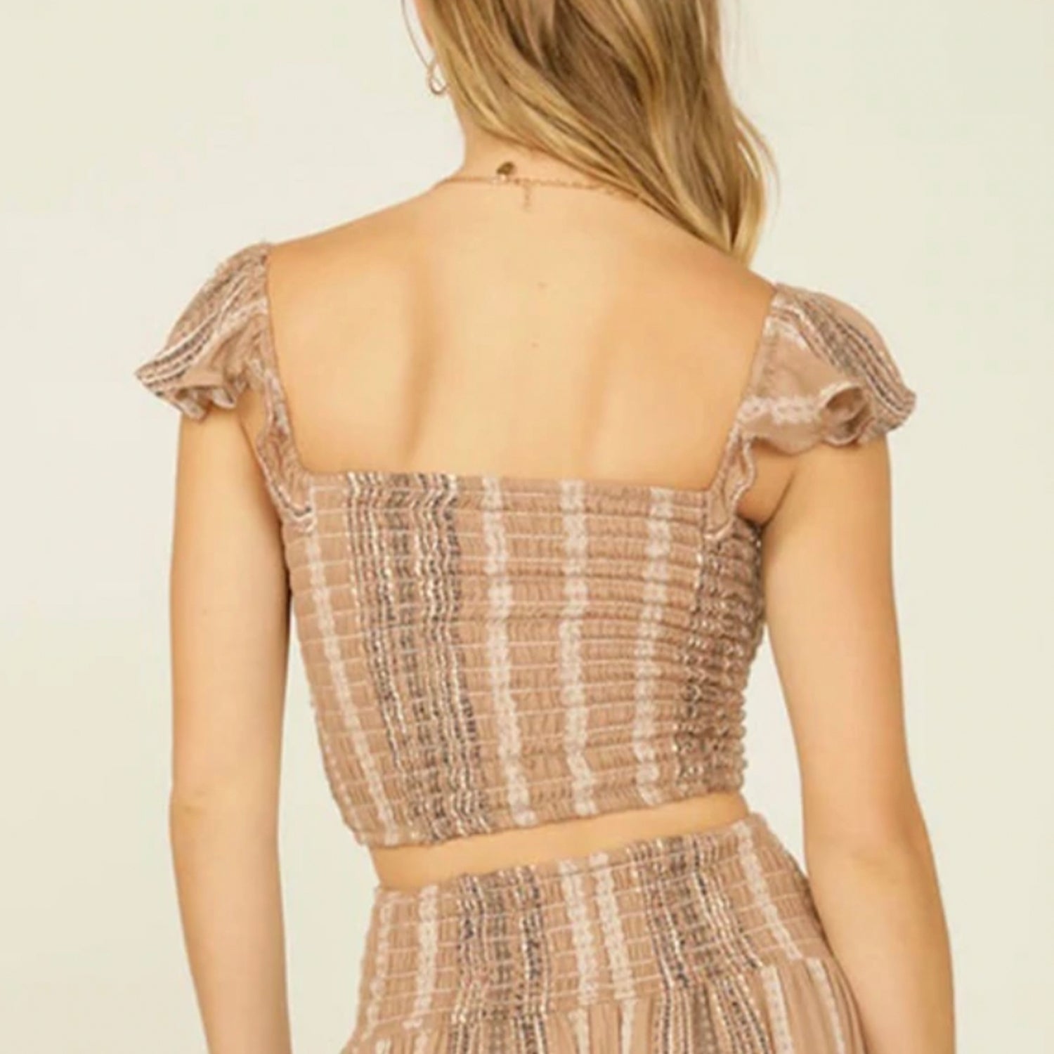 Smocked Tank Ruffle Sleeve. A comfy cropped tank with a feminine twist. Designed in stretchy smocked fabric with ruffle sleeves and a flattering V crop