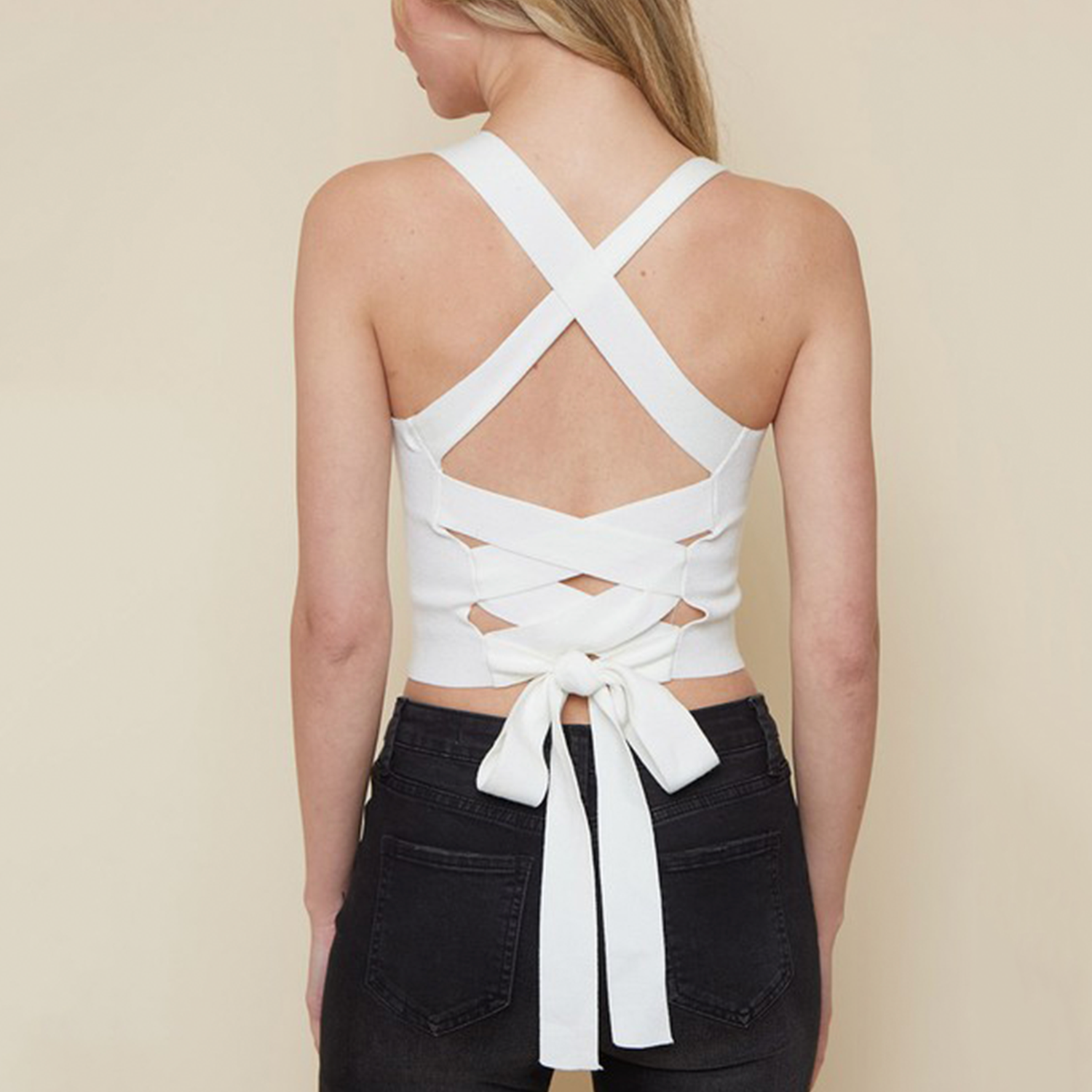 Criss Cross Back Ribbed Knit Cami. This top is a summer vacation must-have! The knitted fabric transitions flawlessly from spring to summer, combined with a fashionable tie-back style in classic white or black. Incredibly soft and incredibly stylish!