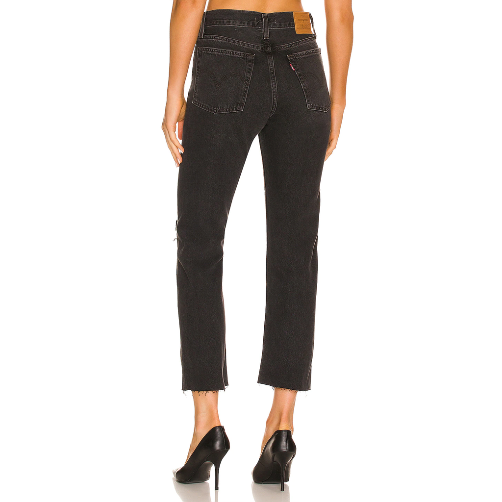 Levi's Wedgie Straight Long Bottom Jean. The After Sunset Levi's Wedgie Straight Jeans complete any outfit! These essential black denim pants are complete with a high waisted fit, a relaxed straight leg, raw hem, distressed detailing, and the iconic brown leather Levi's patch at the back