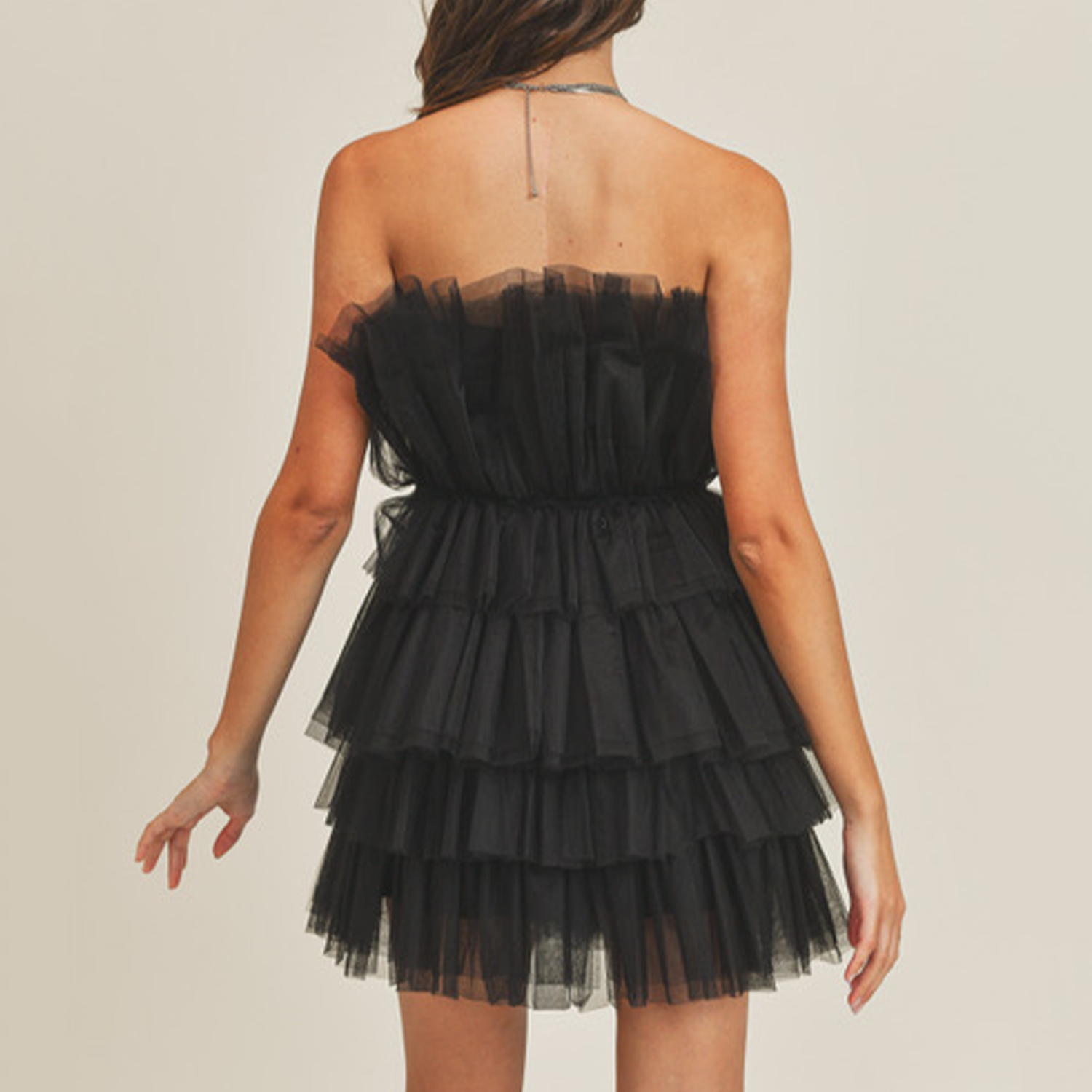 Channel your inner supermodel and make a statement in this dress! This dress features tulle layering and a ruffle tulle detail at the neckline. Perfect for a fun night out or for an upcoming event!